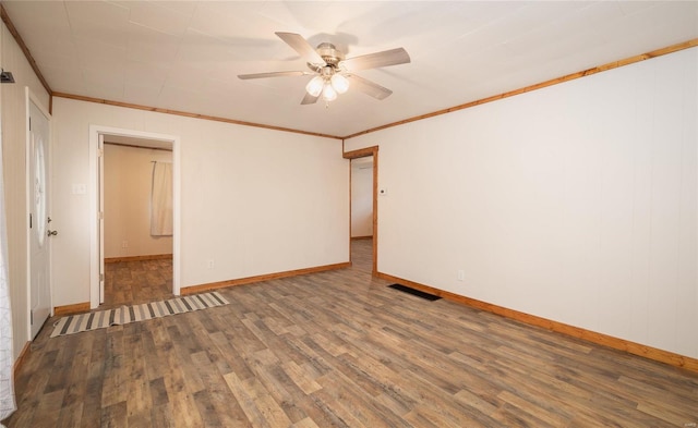 unfurnished room with ornamental molding, ceiling fan, and dark hardwood / wood-style flooring