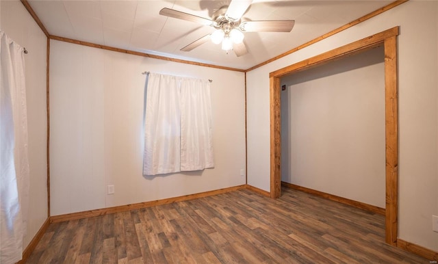 interior space with ornamental molding, ceiling fan, and dark hardwood / wood-style floors