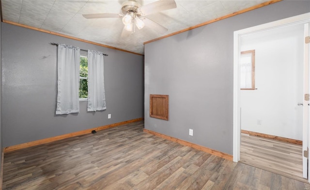 spare room with ceiling fan, hardwood / wood-style flooring, and ornamental molding