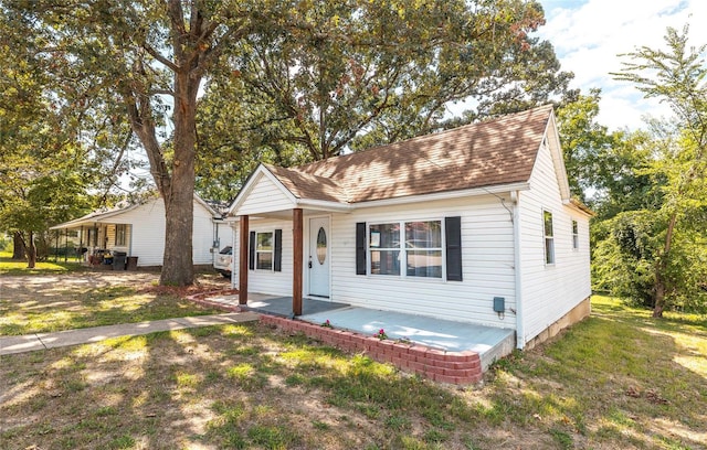 view of front of house with a patio area and a front yard