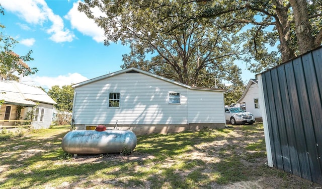 view of property exterior with a lawn