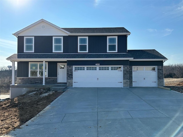 front of property featuring a porch and a garage