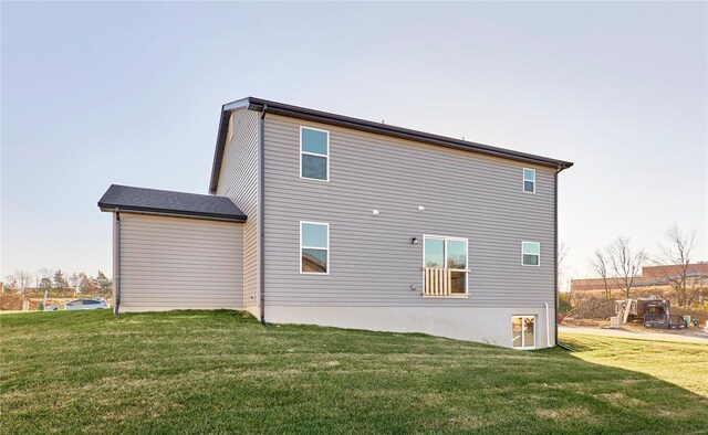 rear view of property with a lawn