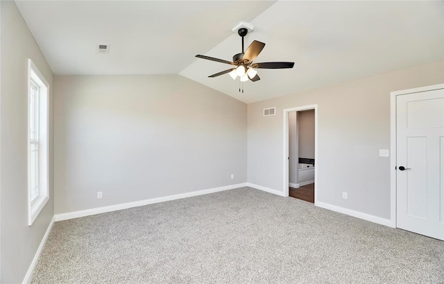 unfurnished bedroom featuring visible vents, vaulted ceiling, and baseboards