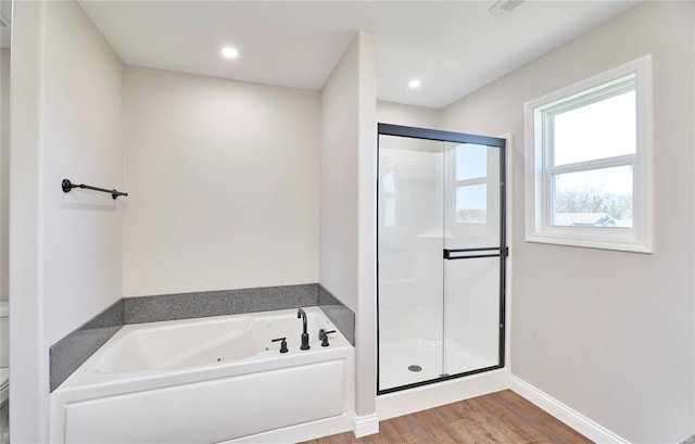 bathroom featuring recessed lighting, a shower stall, wood finished floors, a whirlpool tub, and baseboards