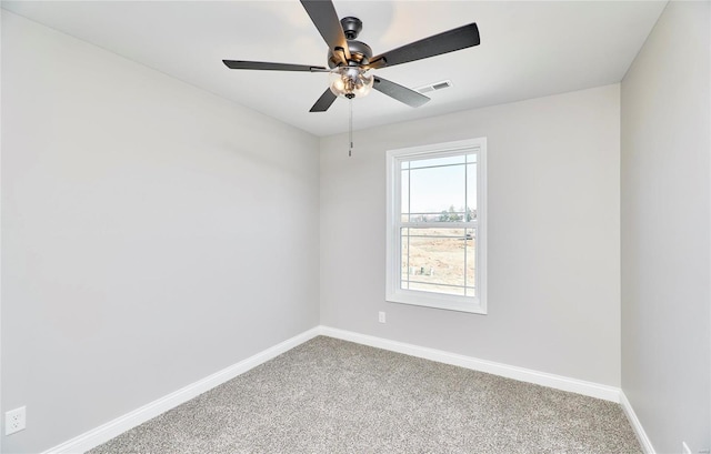 carpeted empty room with a ceiling fan, visible vents, and baseboards