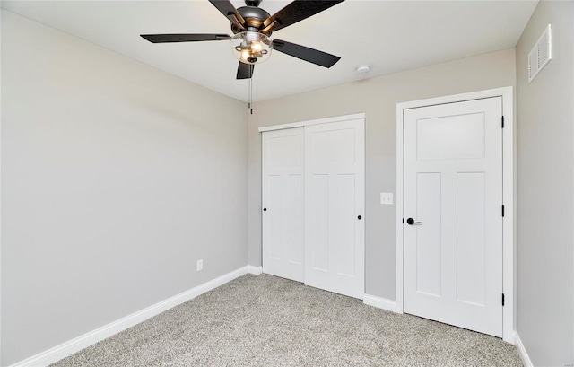 unfurnished bedroom featuring light carpet, a ceiling fan, visible vents, baseboards, and a closet