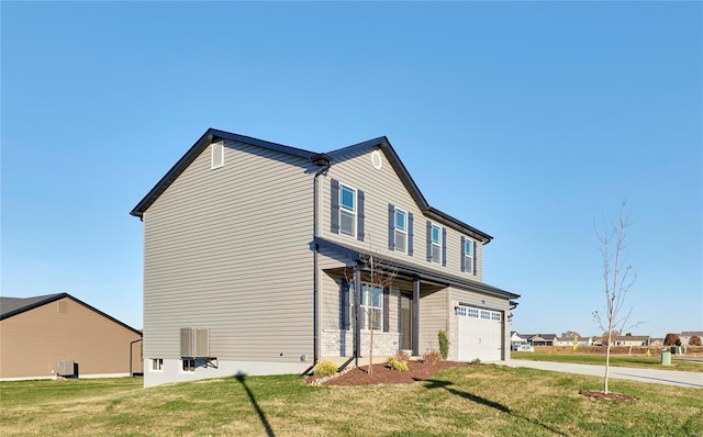 view of front of home featuring a garage, concrete driveway, and a front lawn