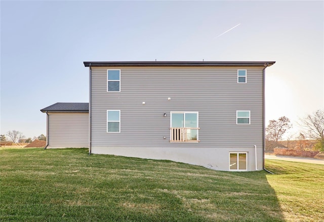 rear view of property featuring a yard