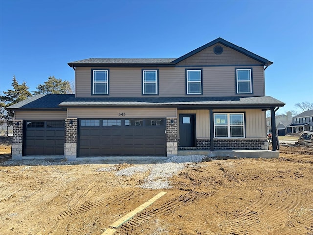 view of front of property with board and batten siding, brick siding, and an attached garage