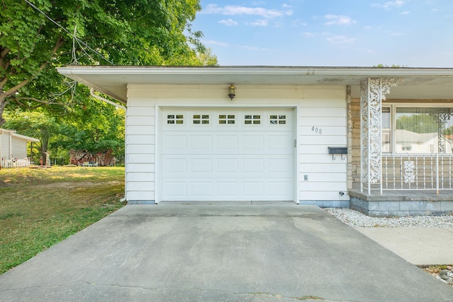 garage featuring wooden walls and a yard