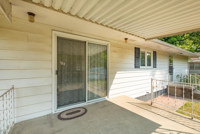 view of exterior entry featuring a patio area