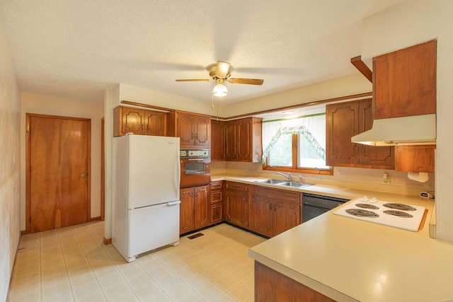 kitchen featuring a textured ceiling, white appliances, ceiling fan, and sink