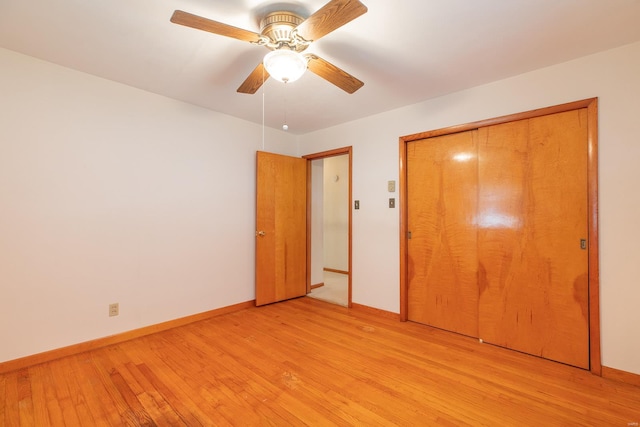 unfurnished bedroom with a closet, light hardwood / wood-style floors, and ceiling fan