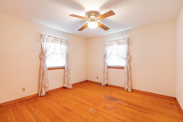 empty room with light wood-type flooring and ceiling fan