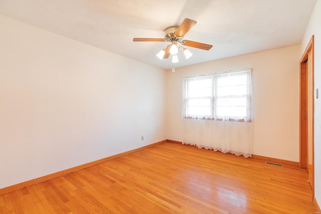 spare room featuring ceiling fan and light hardwood / wood-style flooring