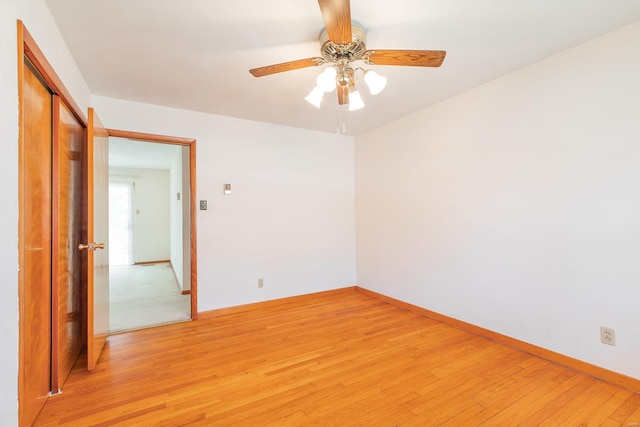 spare room with light hardwood / wood-style floors and ceiling fan