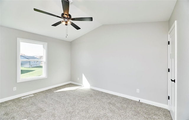 unfurnished room with ceiling fan, carpet floors, and vaulted ceiling