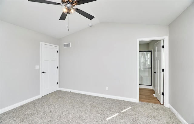 carpeted empty room featuring lofted ceiling and ceiling fan