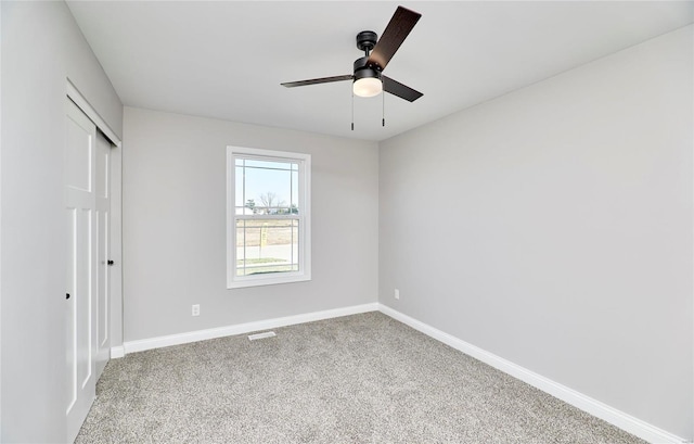 unfurnished bedroom featuring carpet floors, a closet, and ceiling fan