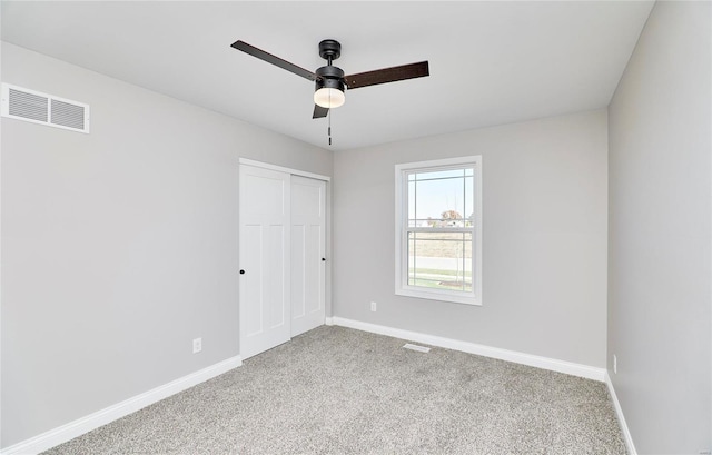 spare room with ceiling fan and carpet flooring