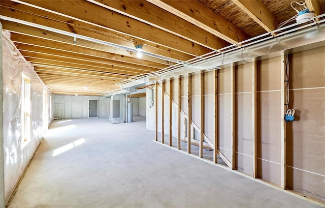 basement with electric panel and water heater