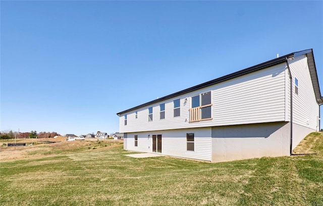 rear view of property with a lawn