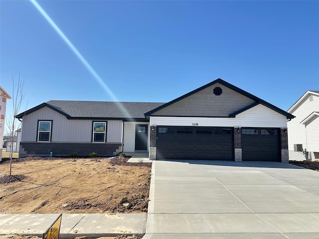 ranch-style home featuring a garage, driveway, and brick siding