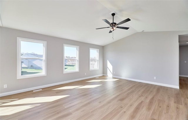 empty room with light hardwood / wood-style floors, vaulted ceiling, and ceiling fan