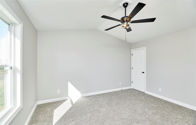 unfurnished room featuring ceiling fan, carpet floors, and vaulted ceiling