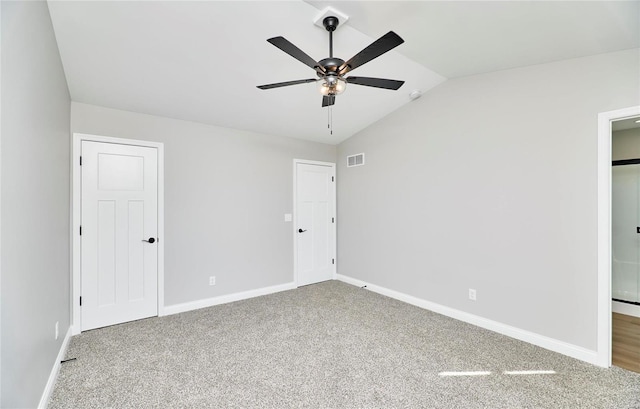 unfurnished bedroom featuring carpet, vaulted ceiling, and ceiling fan