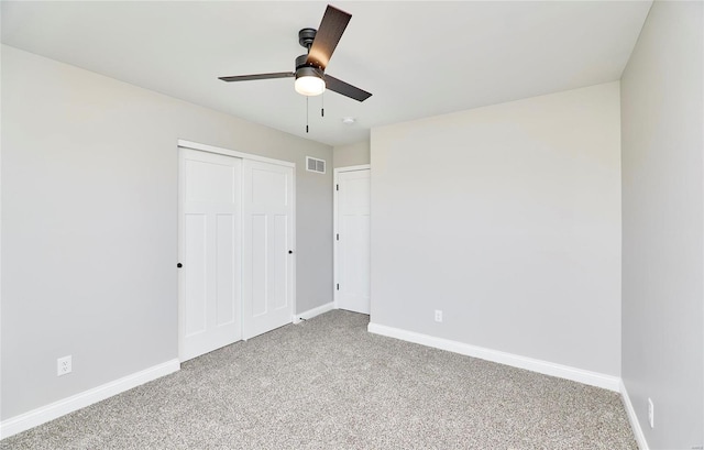 unfurnished bedroom with carpet, a closet, and ceiling fan