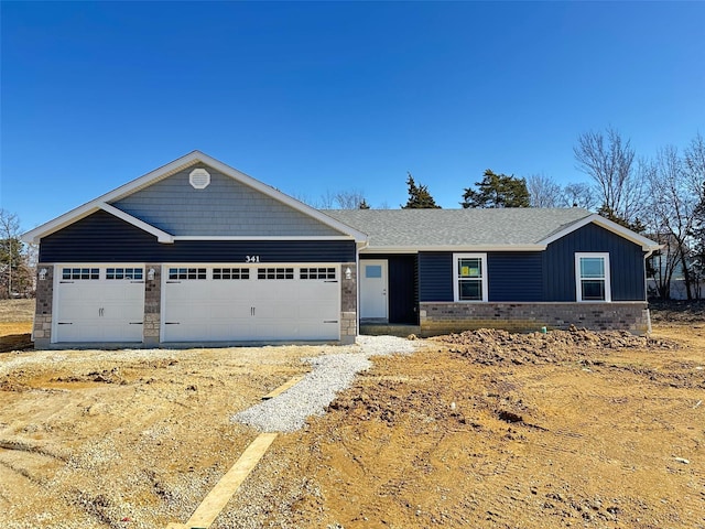 view of front facade with dirt driveway and an attached garage