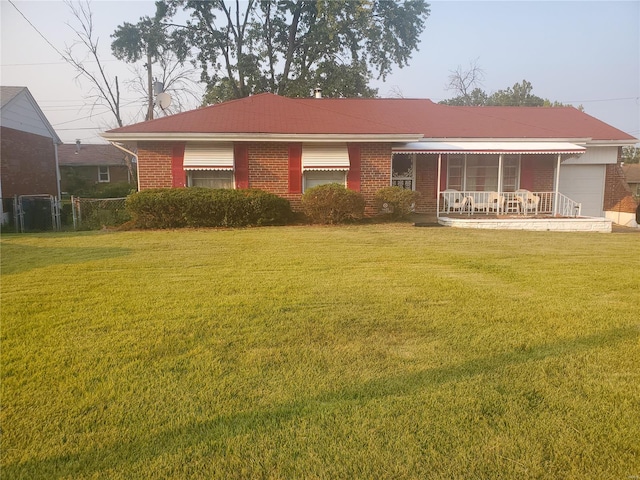 ranch-style house featuring a porch and a front yard