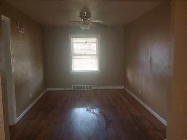 unfurnished room with dark hardwood / wood-style floors and ceiling fan