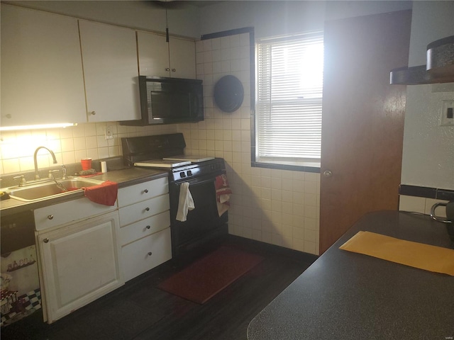 kitchen featuring tile walls, white cabinetry, tasteful backsplash, black appliances, and sink