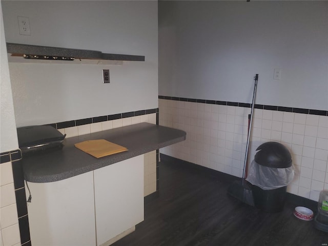 kitchen with white cabinets, tile walls, and dark wood-type flooring