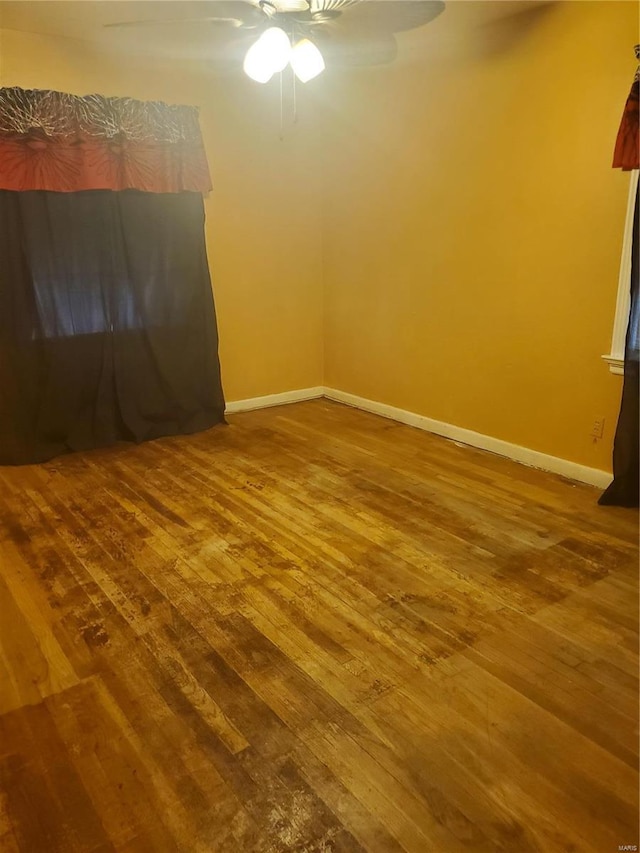 empty room featuring ceiling fan and hardwood / wood-style flooring