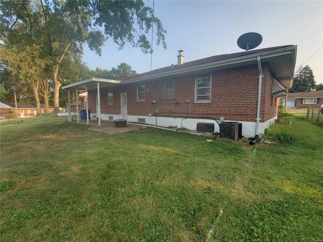 back of house featuring a patio, central air condition unit, and a yard