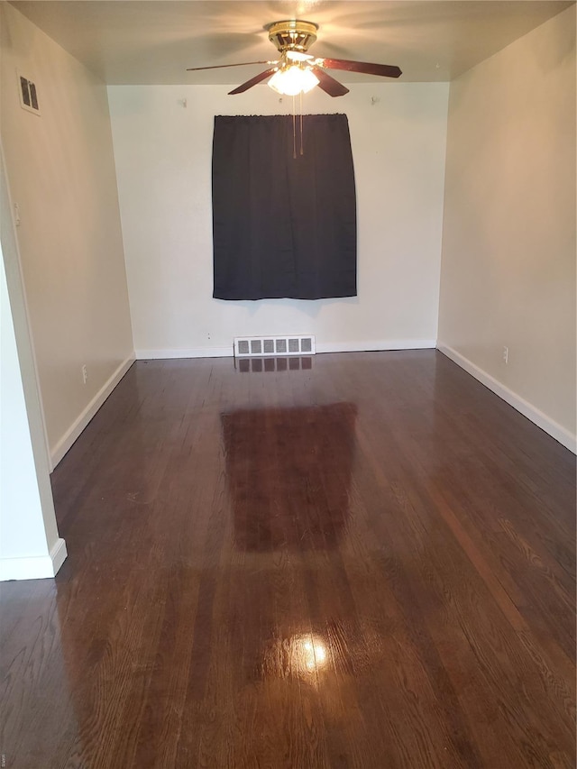 unfurnished room featuring visible vents, baseboards, ceiling fan, and wood finished floors