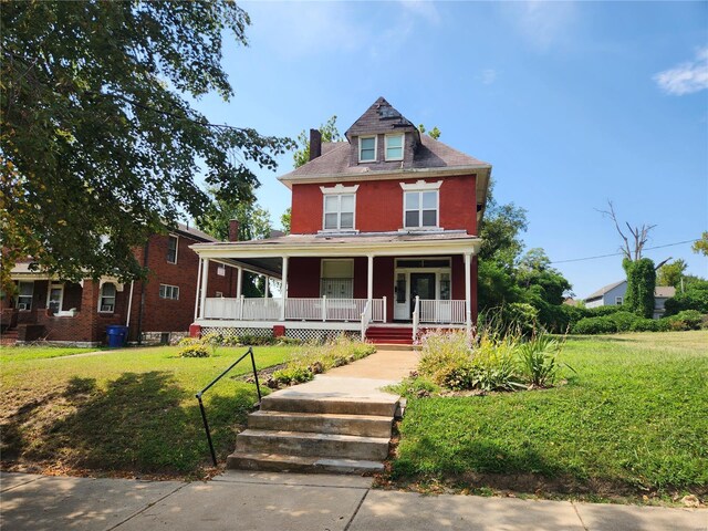 view of front of property with a porch and a front lawn