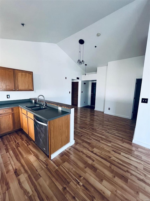 kitchen with black dishwasher, decorative light fixtures, sink, dark hardwood / wood-style floors, and high vaulted ceiling