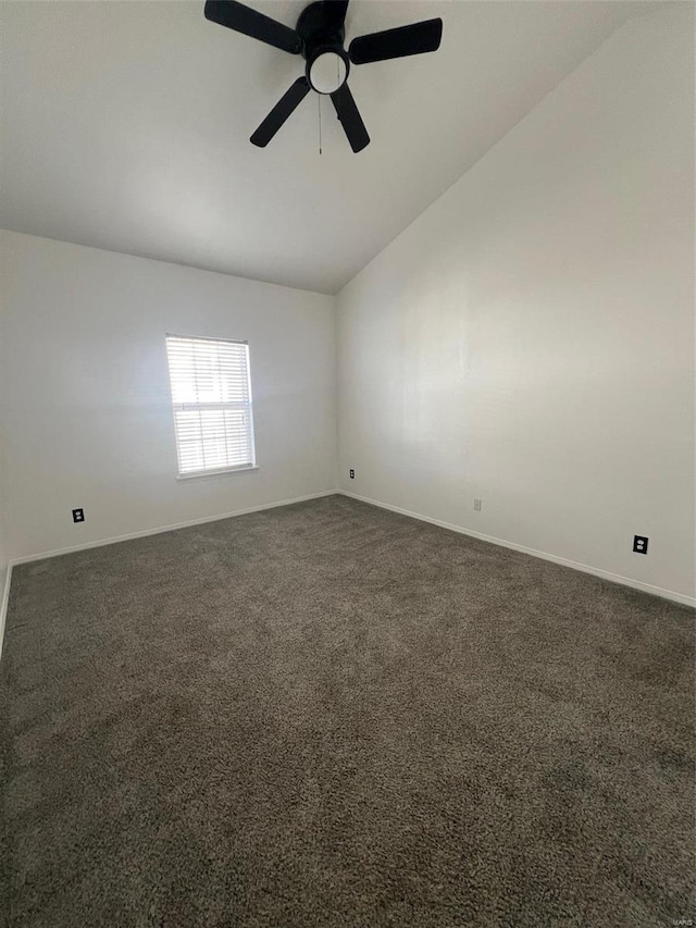 spare room featuring ceiling fan, lofted ceiling, and dark colored carpet