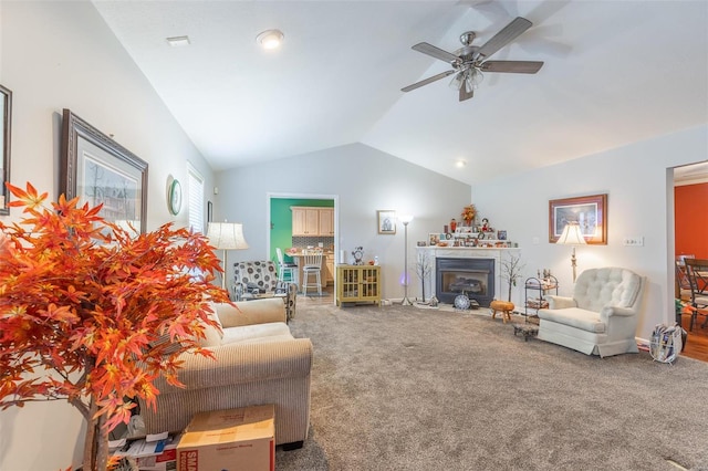 living room featuring ceiling fan, vaulted ceiling, and carpet