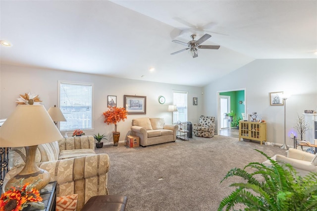 living room with ceiling fan, vaulted ceiling, and carpet