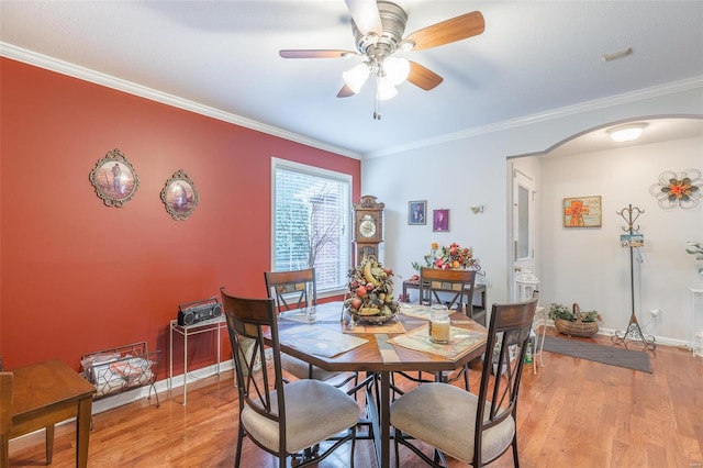 dining room featuring light wood-type flooring, ceiling fan, and crown molding