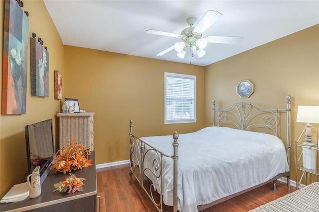 bedroom with ceiling fan and dark hardwood / wood-style flooring