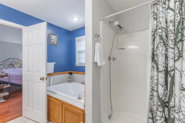 bathroom with plus walk in shower and hardwood / wood-style flooring