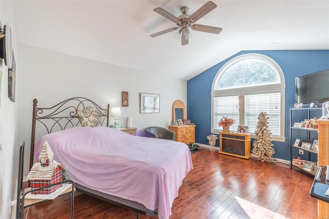 bedroom featuring ceiling fan, dark wood-type flooring, and vaulted ceiling