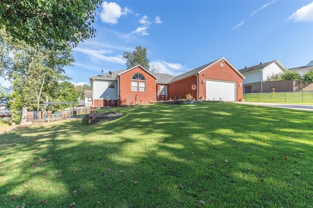 single story home featuring a front lawn and a garage